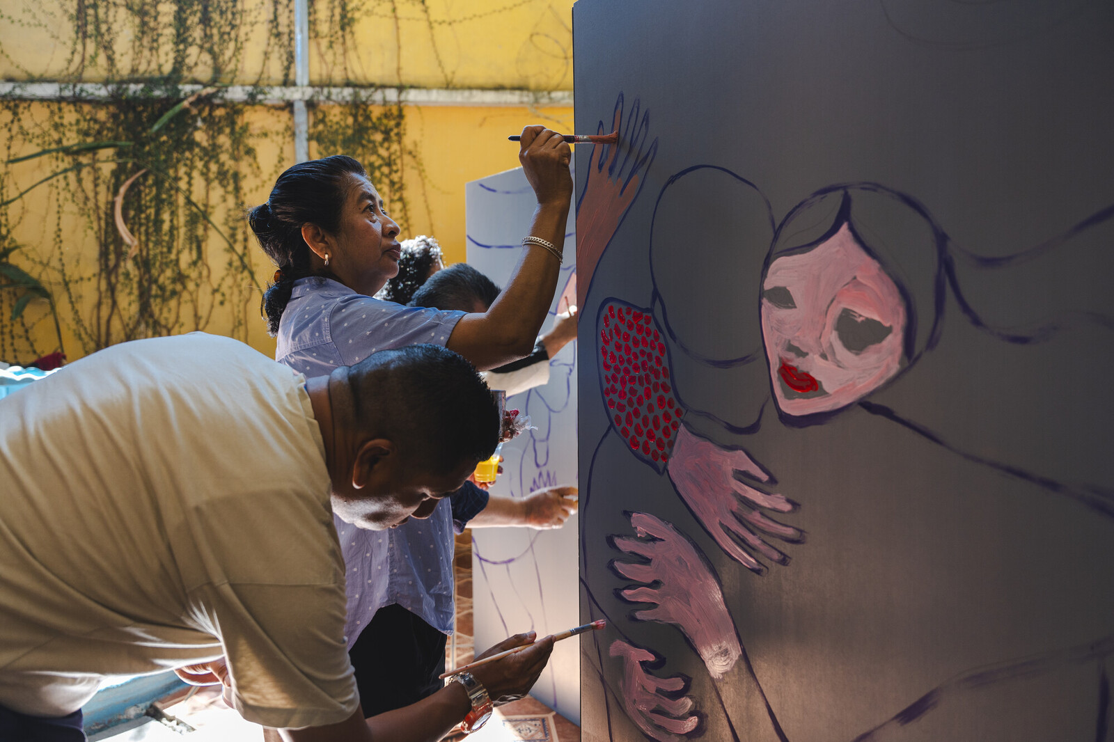 photo of woman painting mural