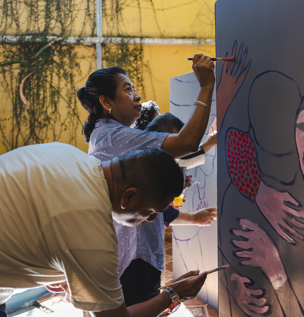 photo of someone painting a mural