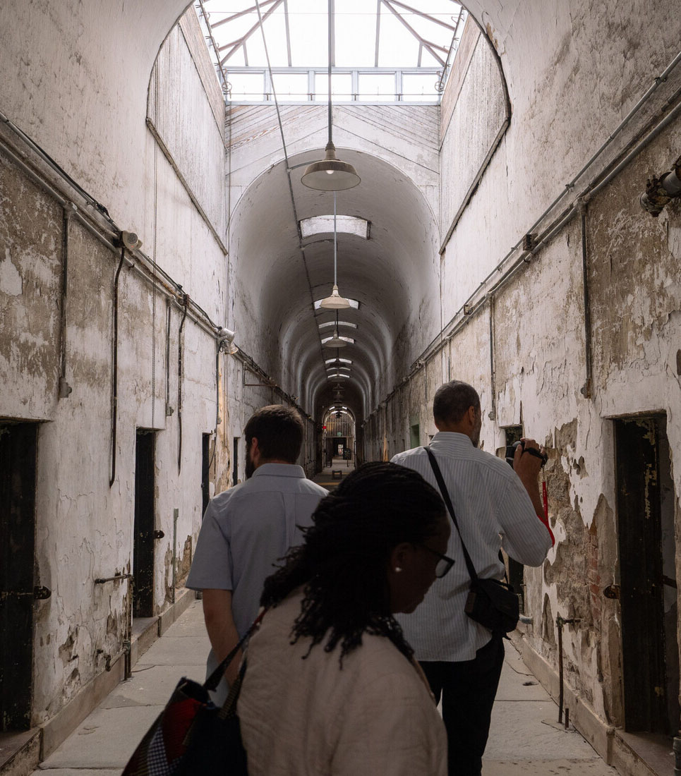 photo of people walking through old prison