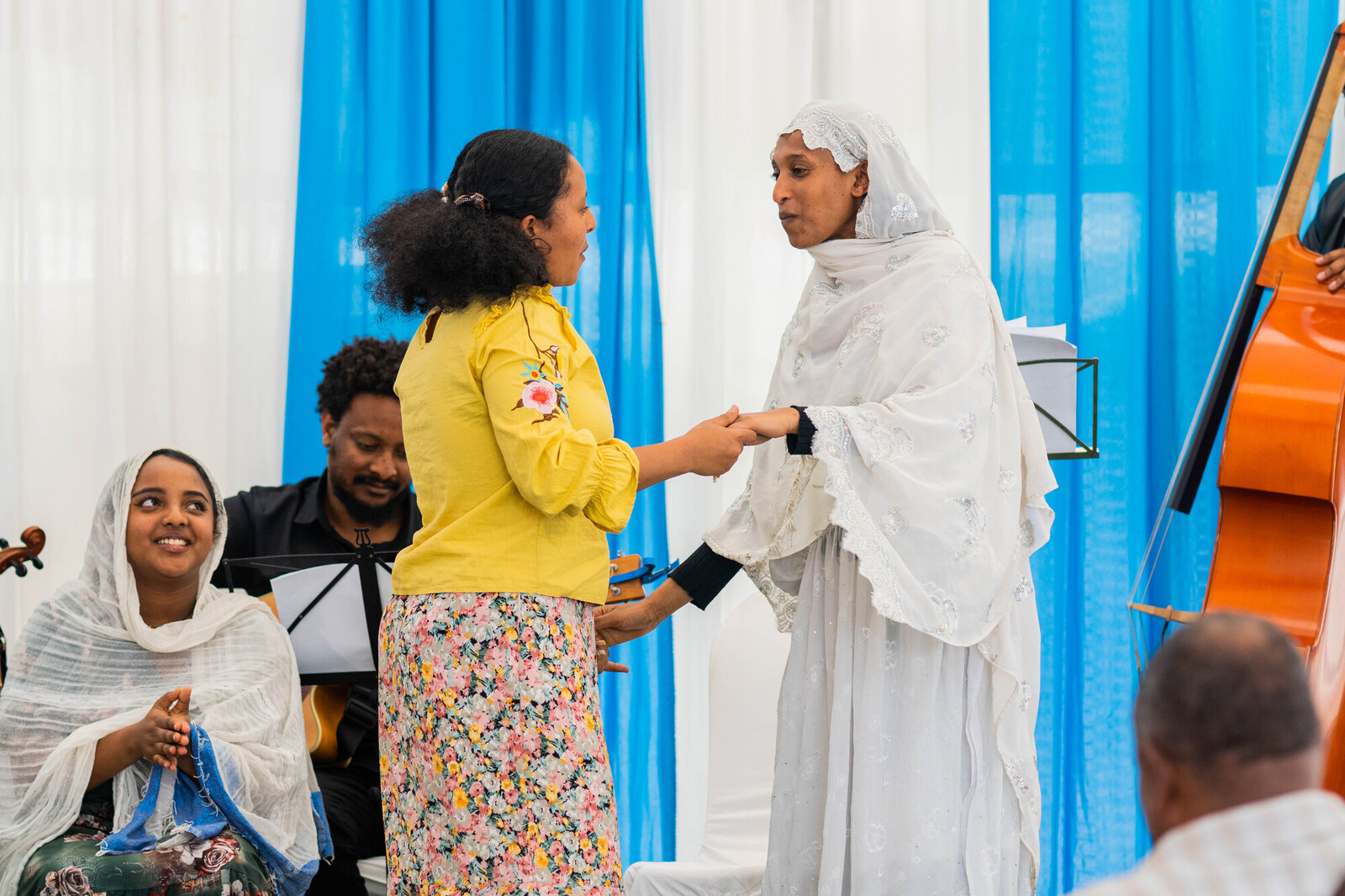people holding hands at peace ceremony 