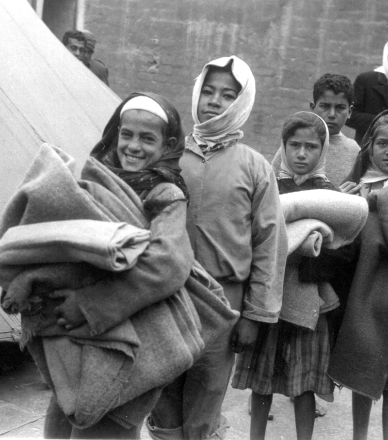 archival image of gaza children carrying supplies