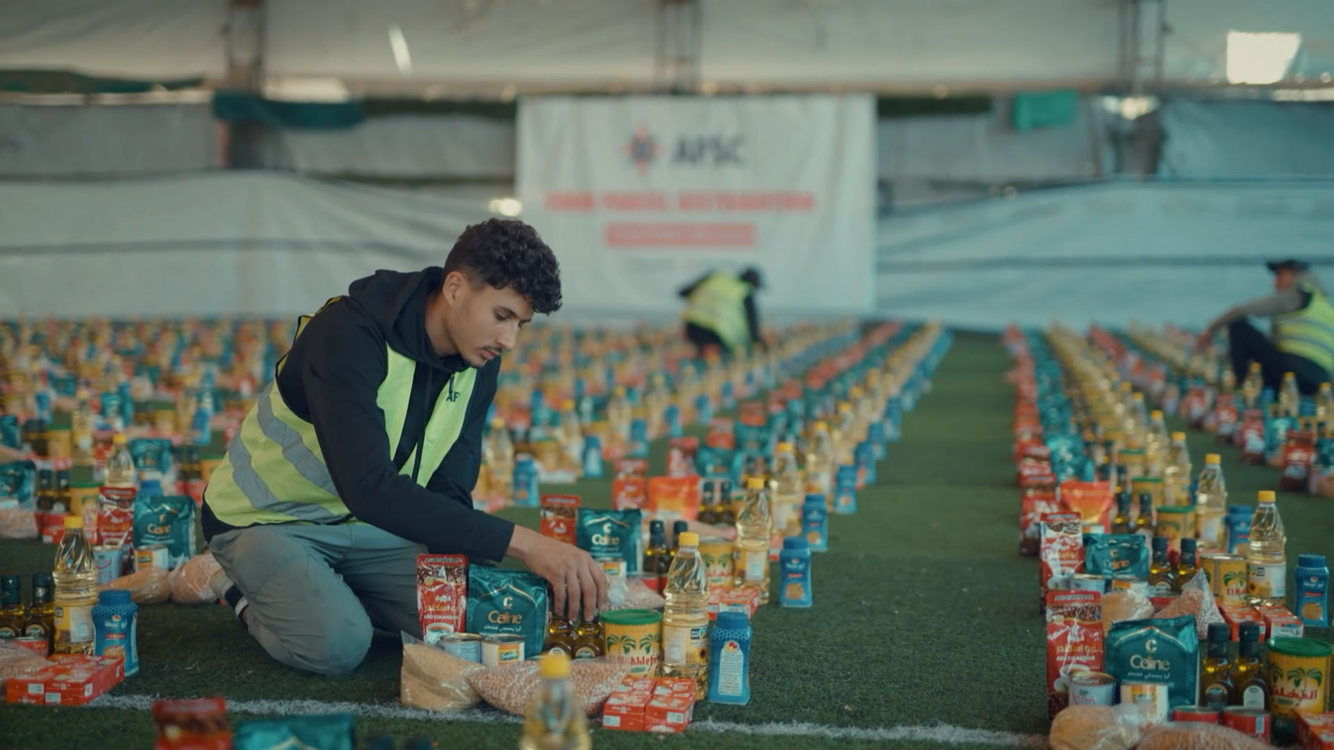 Worker preparing food parcels for delivery