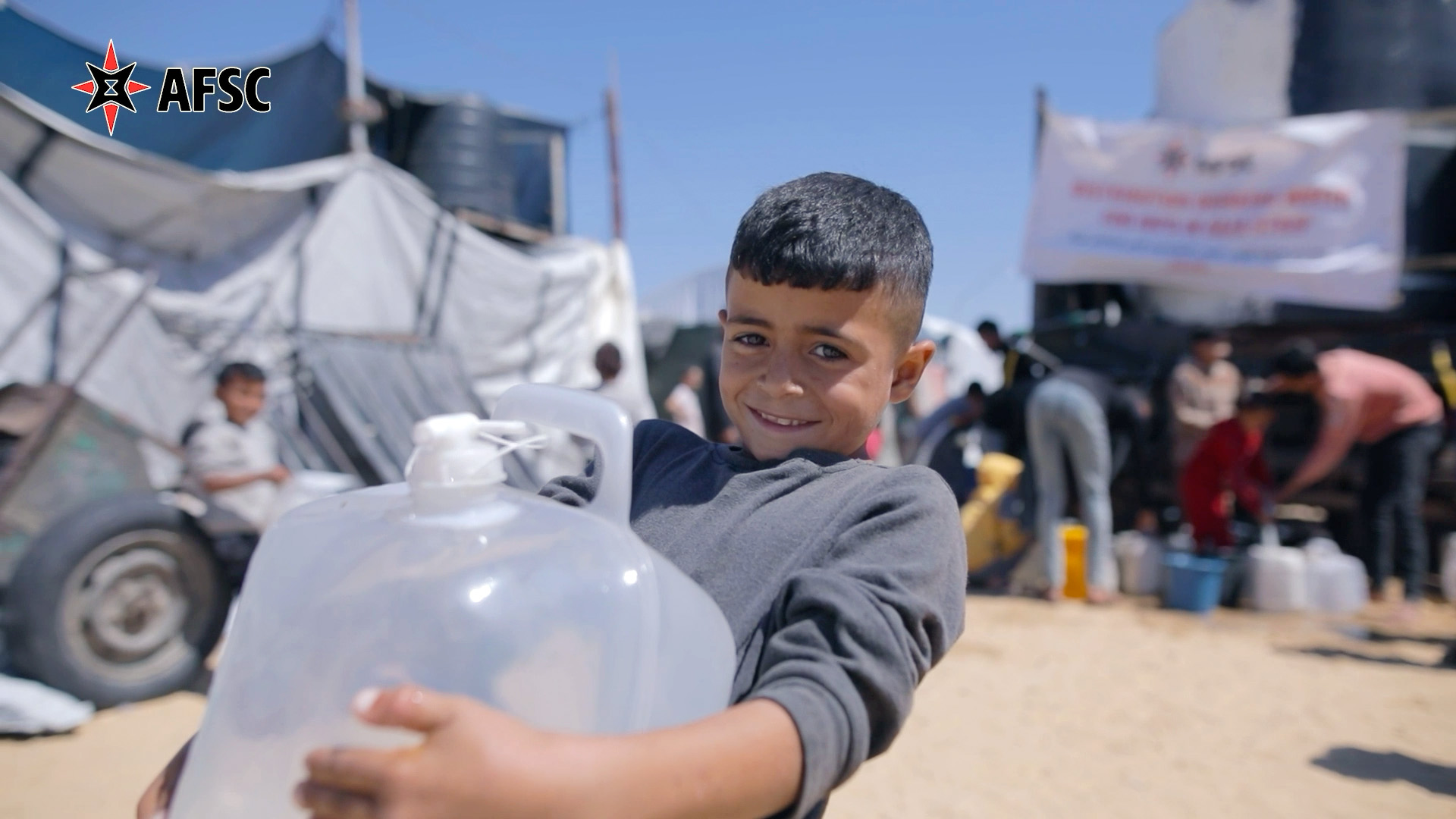 Child holding a large jug of water
