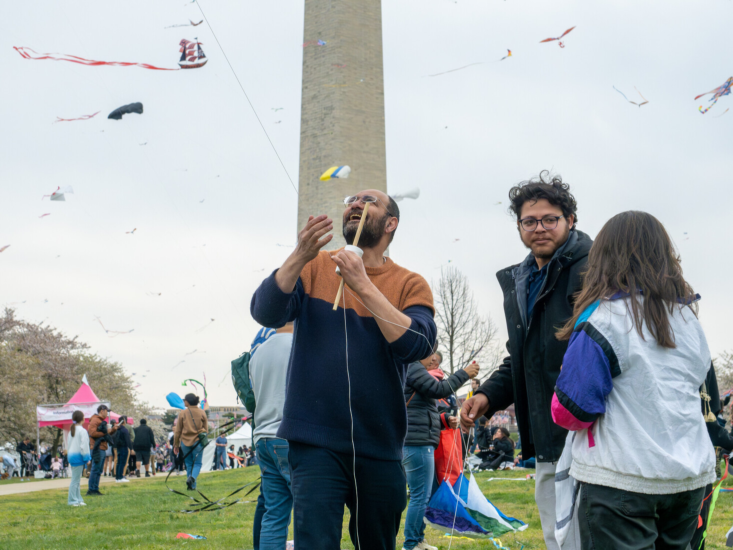 a group of people flying kites in the sky for gaza on a bright spring day