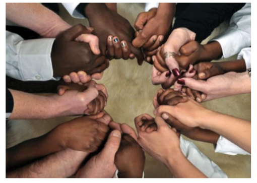 Many hands holding one another in a circle
