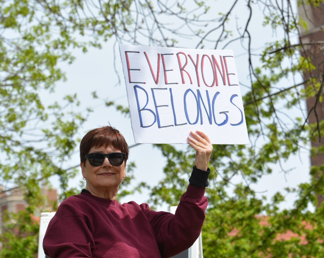 a Friend holding a sign that says 