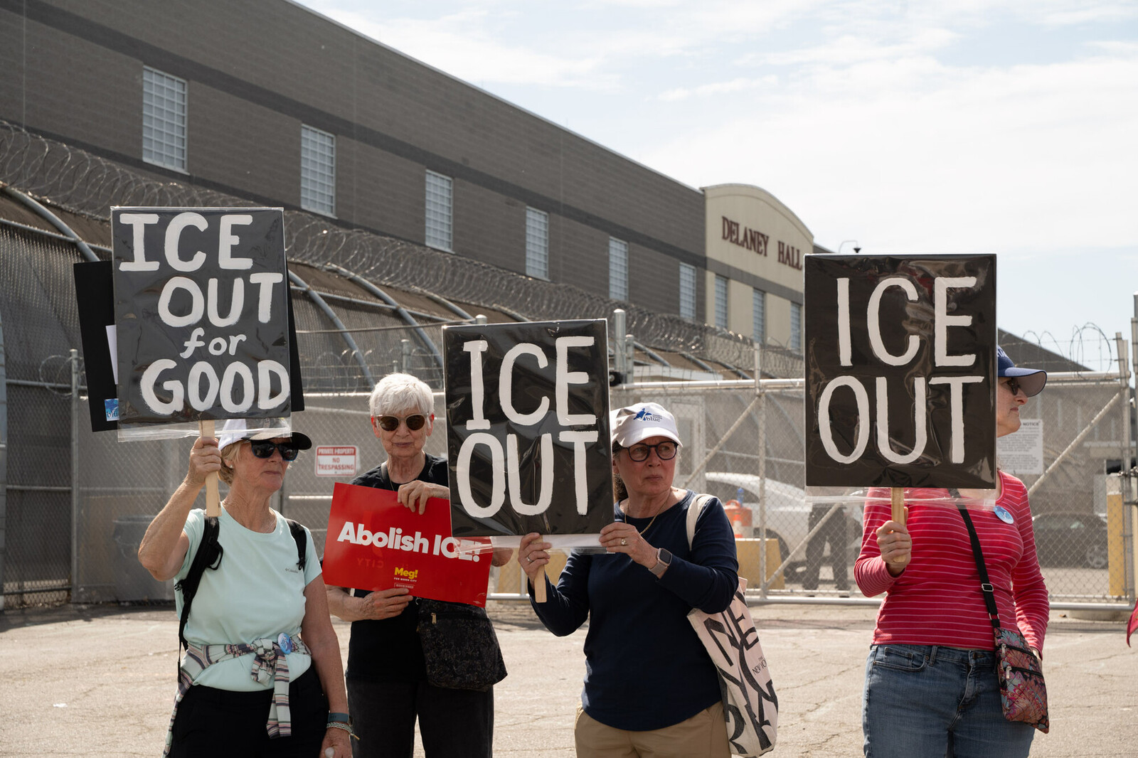 4 people hold signs saying 