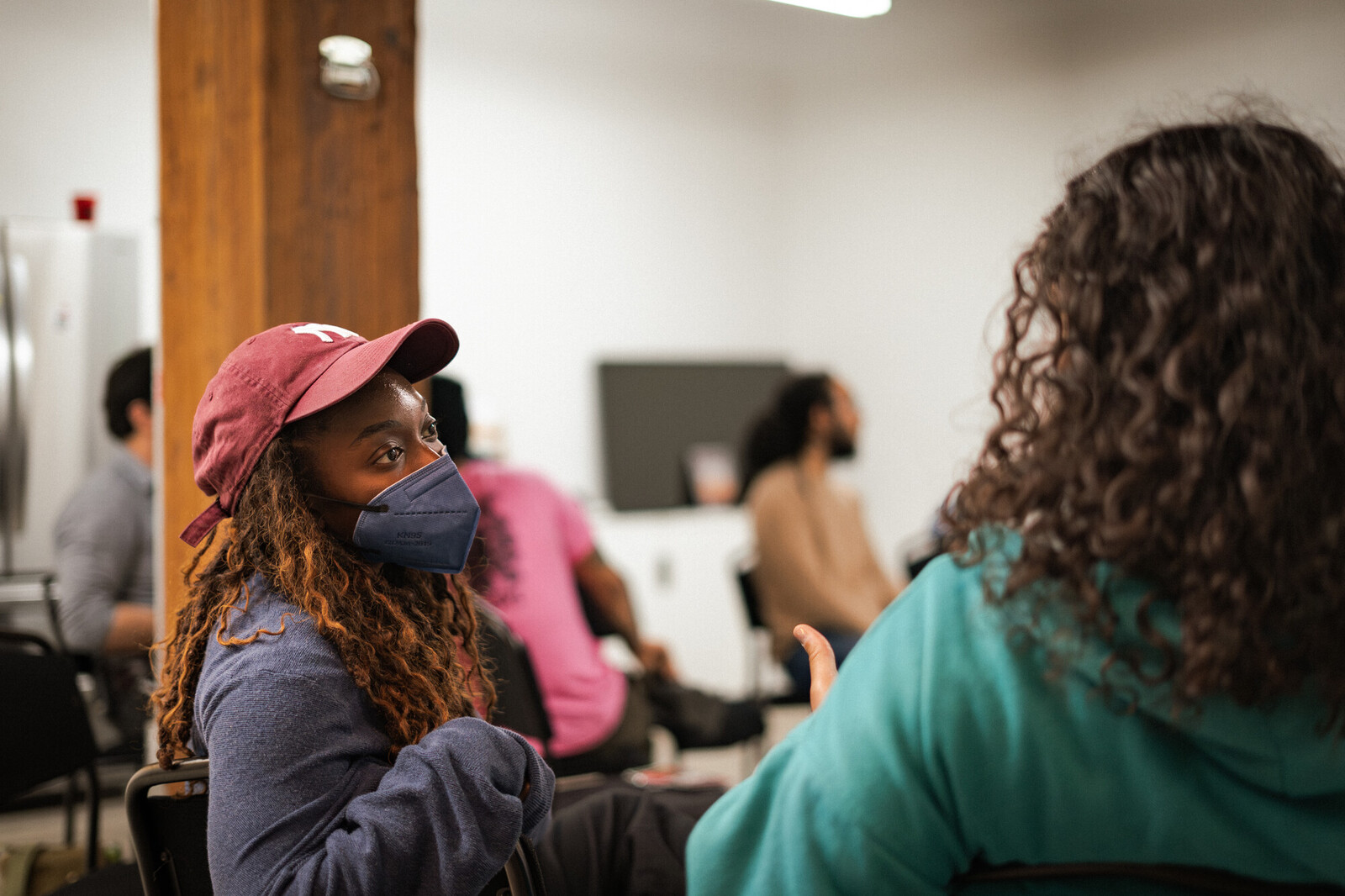 asia smith speaks with a young person at Peaceful Careers Fair