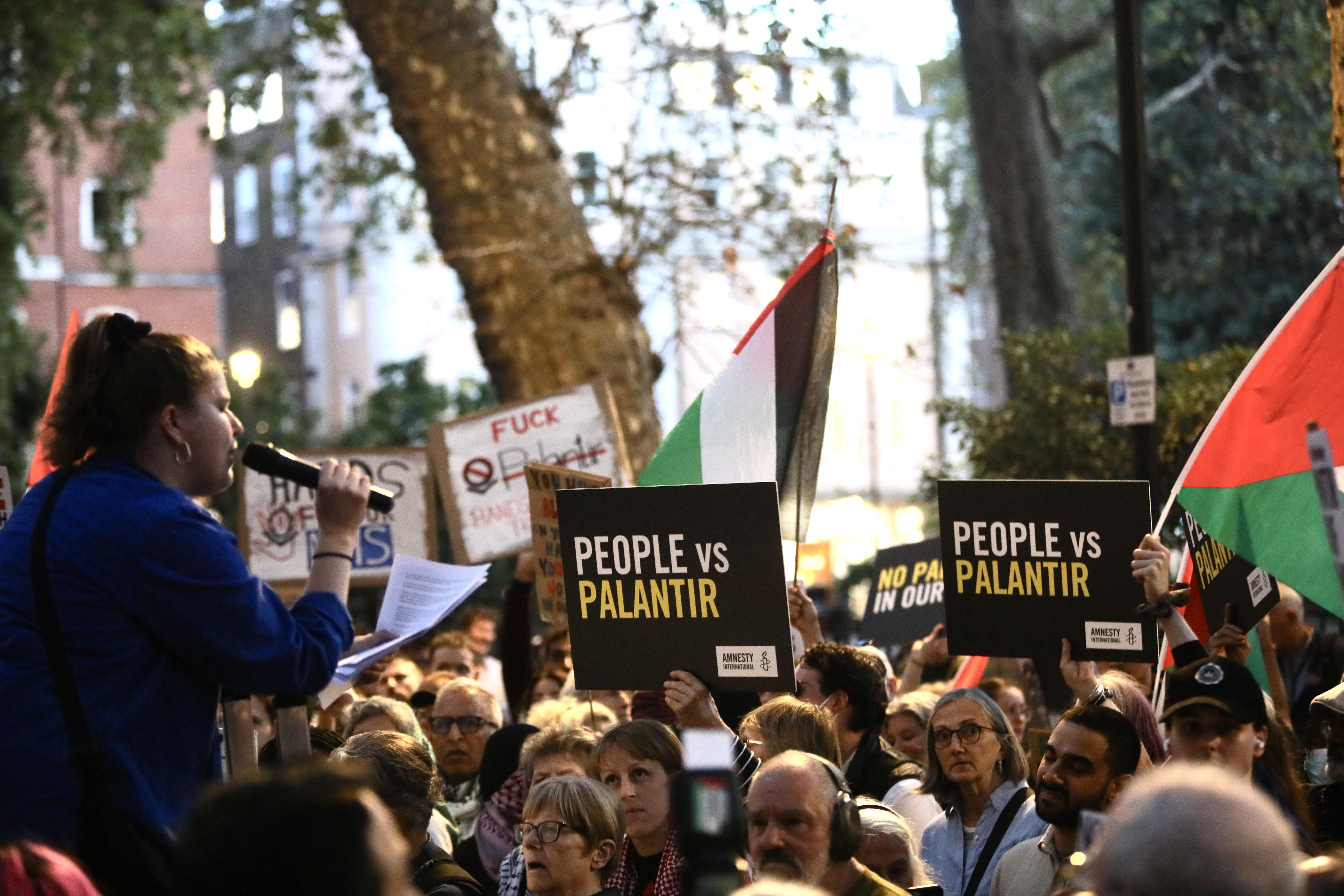 Rally with people holding signs that read 