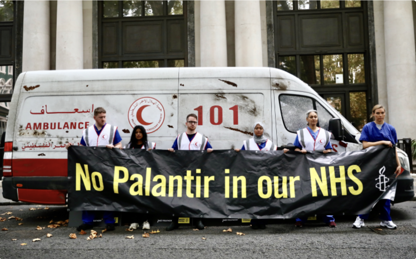 UK healthworkers hold a sign reading 