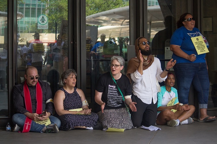 Chanting and singing at HUD while blocking the doors, photo by Carl Roose