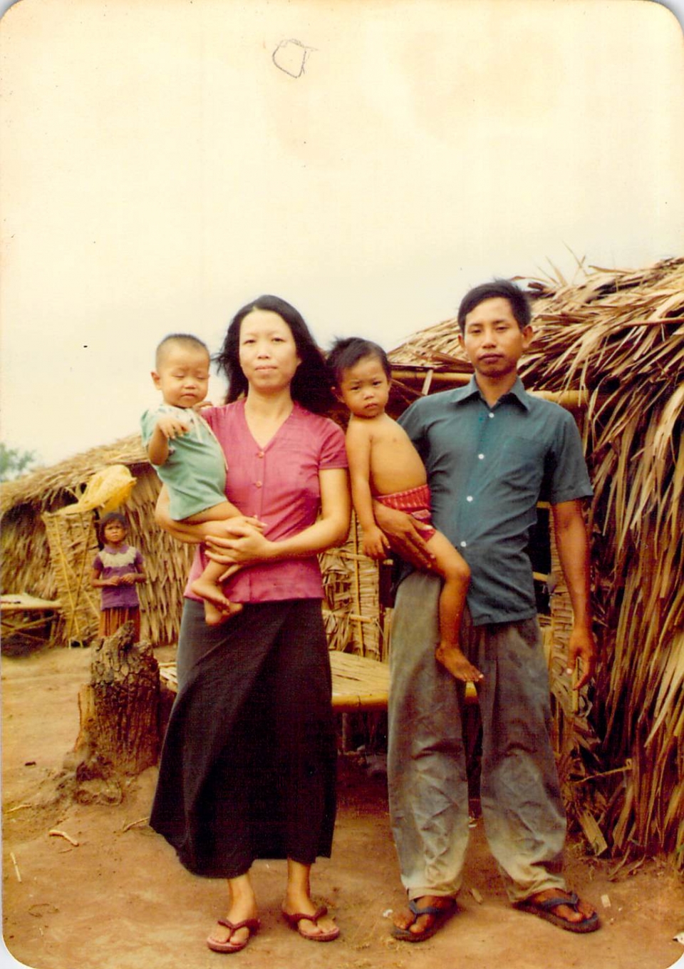 The Be family at a Thailand refugee camp in 1979, with the author as a child at right.