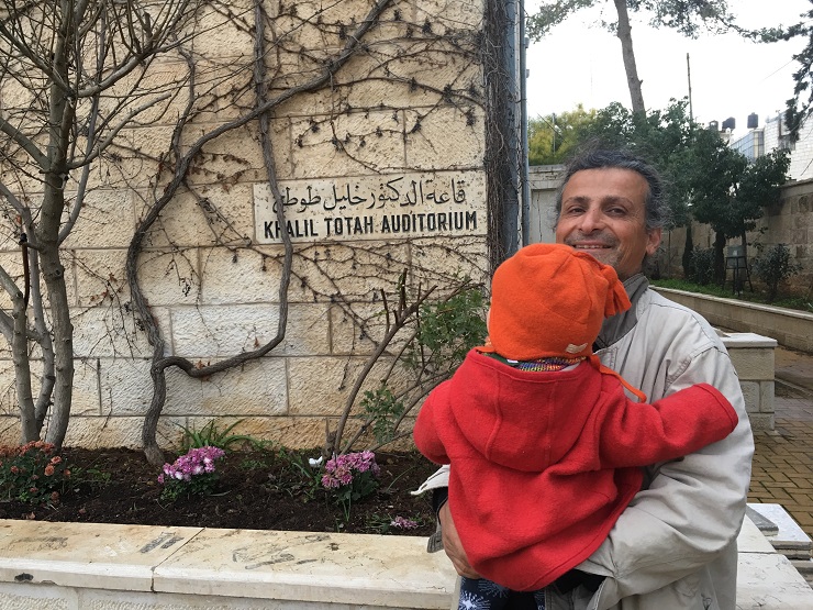 My husband Saleh and our son in front of Friends School Ramallah building by Morgan Cooper