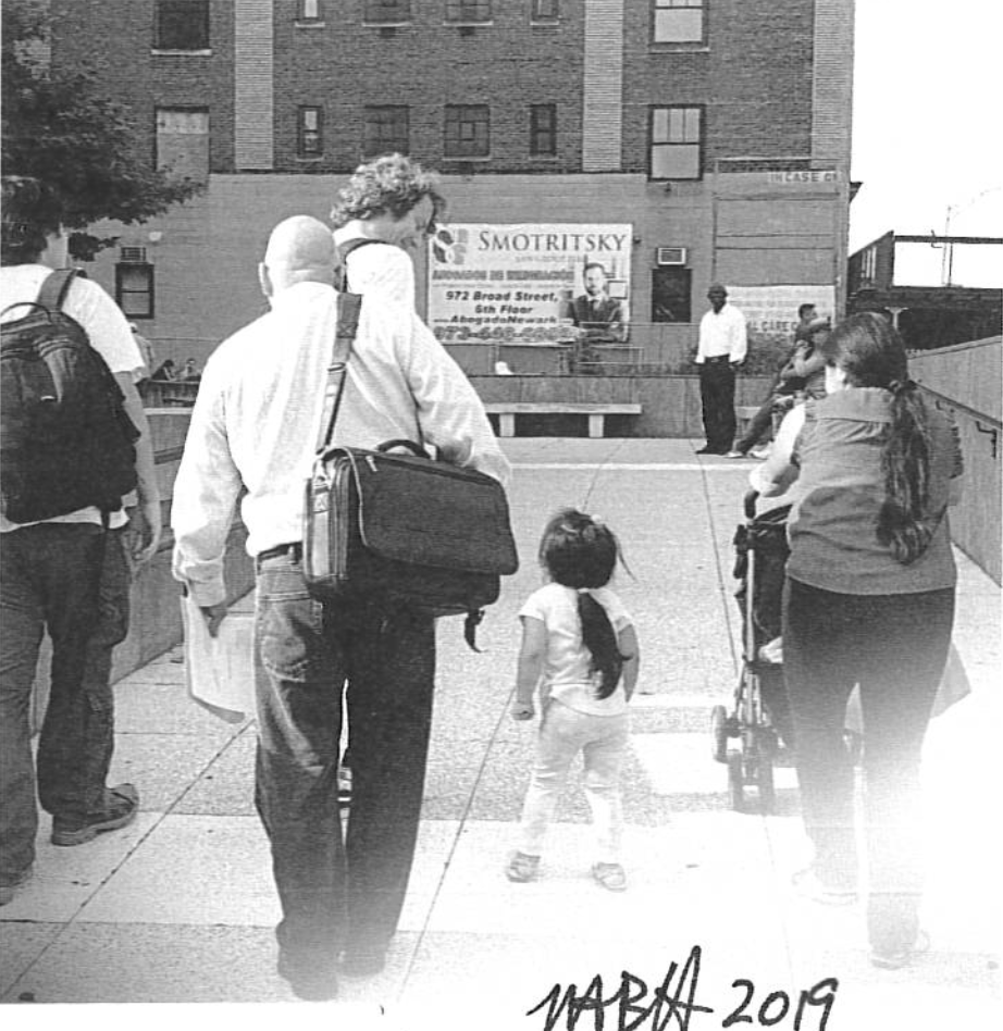 AFSC supervising attorney Lloyd Munjack with a client and her two children in 2019. Photo: Monica Bottone